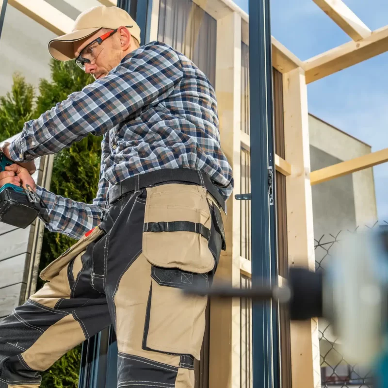First fix for a builder with a drill finishing the carpentry work on an annexe extension in berkshire