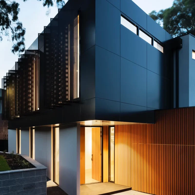 Building completed by forest builders with corner entrance and space like modern cladding subtle lighting beneath the trees